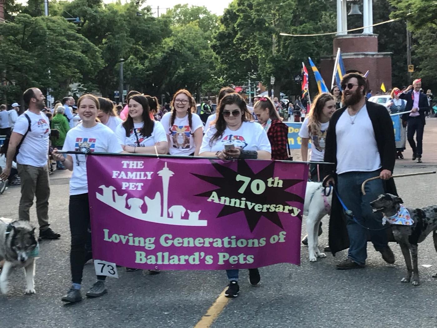 The Family Pet team marching in Ballard’s Syttende Mai parade behind a banner reading “The Family Pet, 70th Anniversary, Loving Generations of Ballard’s Pets”
